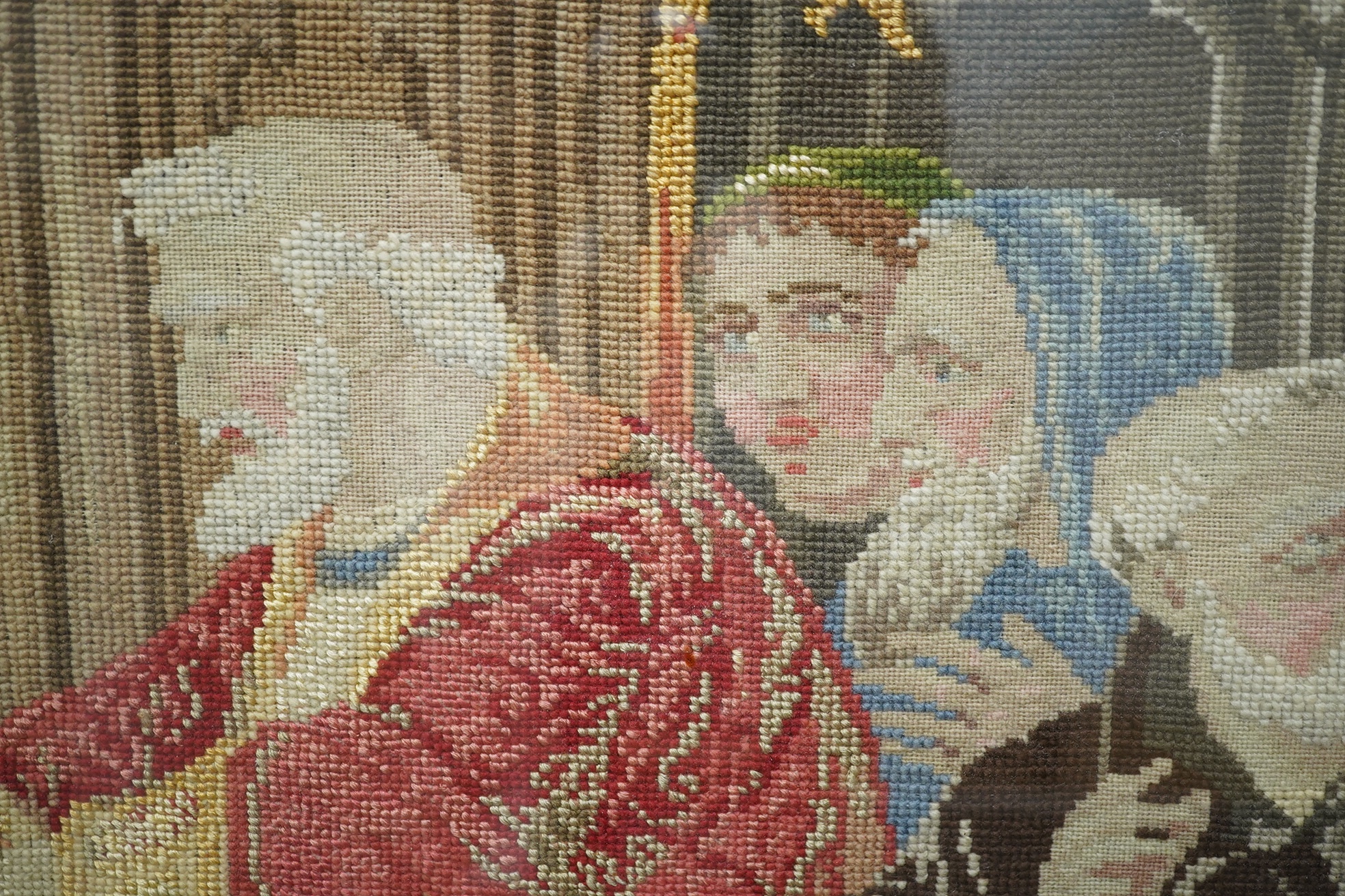 A large gilt framed English 19th century Berlin wool work, in mixed gross point and petit point, the embroidery a medieval scene of Cardinal Wolsey meeting the Archbishop of Canterbury and many courtiers and attendants o